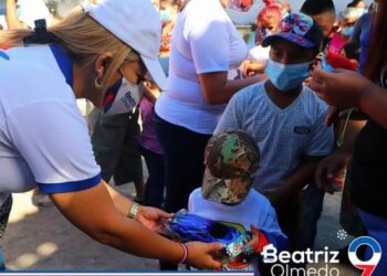 Beatríz Olmedo y Elmer Cardoza regalando juguetes en Ciudad Delgado